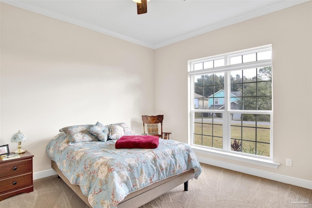 carpeted bedroom featuring ceiling fan and ornamental molding