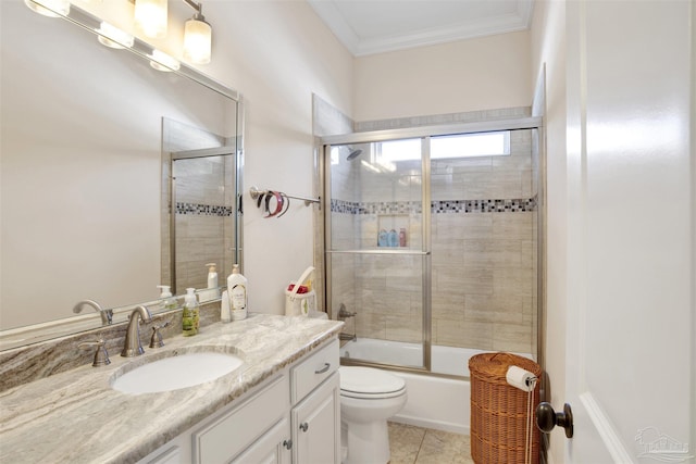 full bathroom with combined bath / shower with glass door, tile patterned floors, ornamental molding, vanity, and toilet