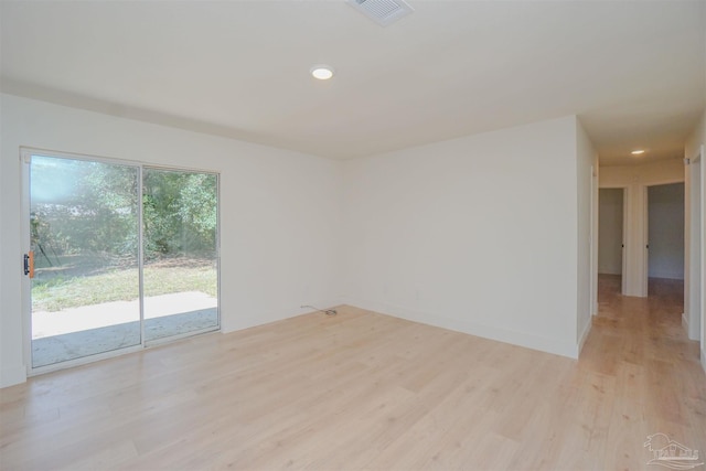 spare room with light hardwood / wood-style flooring