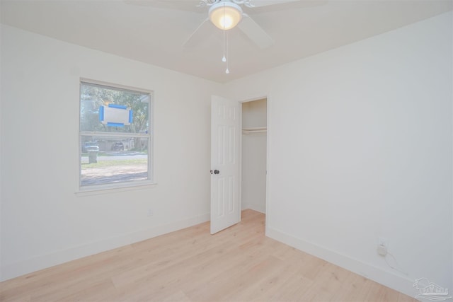 empty room featuring light wood-type flooring and ceiling fan