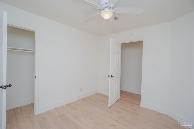 unfurnished bedroom with light wood-type flooring, a closet, and ceiling fan