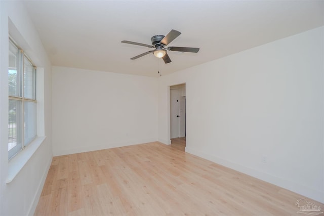 spare room featuring plenty of natural light, ceiling fan, and light hardwood / wood-style floors