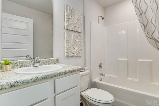 full bathroom with toilet, vanity, and shower / washtub combination