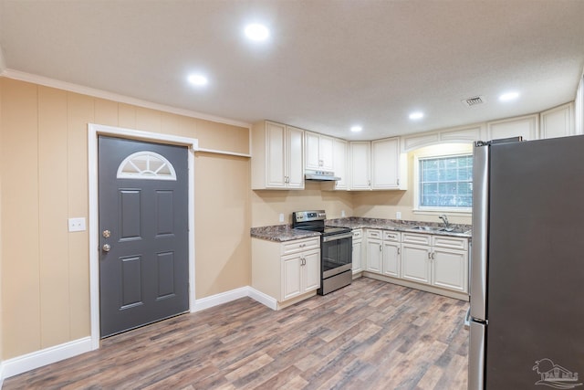 kitchen featuring hardwood / wood-style flooring, sink, white cabinetry, stainless steel appliances, and crown molding