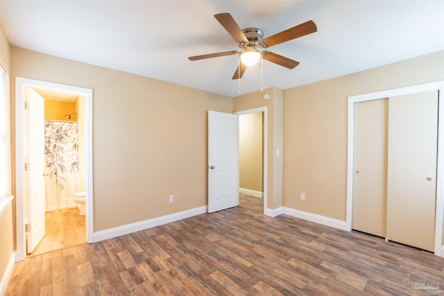 unfurnished bedroom with ceiling fan, dark hardwood / wood-style floors, and ensuite bathroom