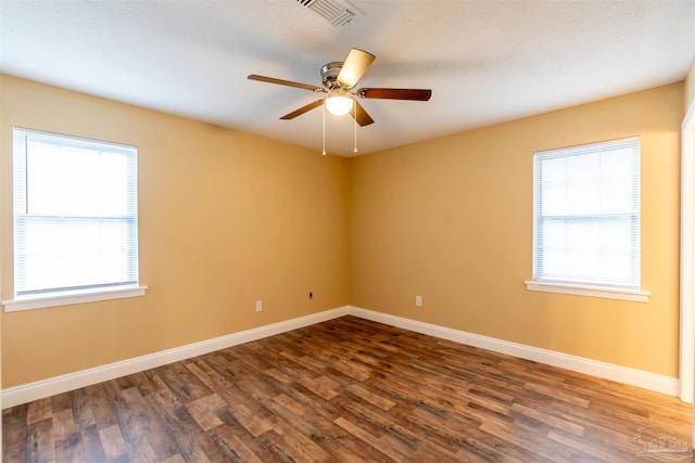 unfurnished room featuring ceiling fan and dark wood-type flooring