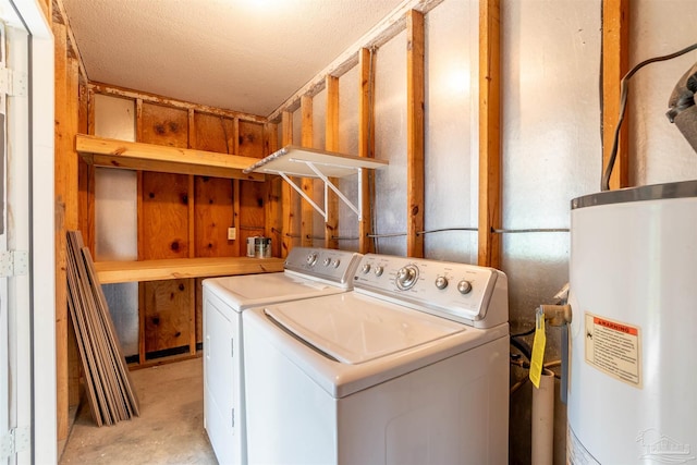 clothes washing area with a textured ceiling, gas water heater, and washing machine and clothes dryer