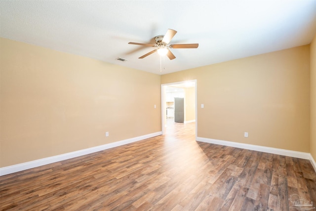 empty room with wood-type flooring and ceiling fan