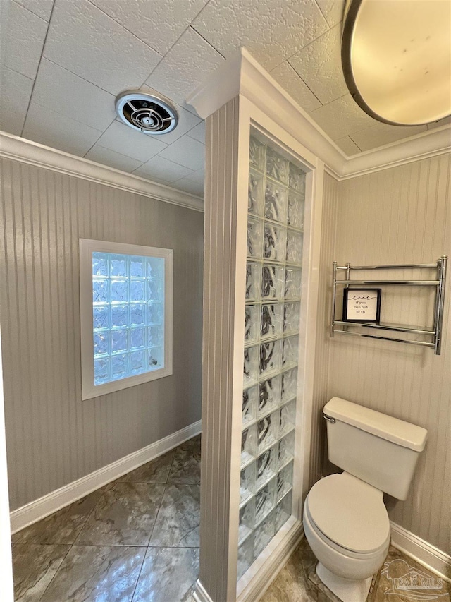 704 E Horner St, Atmore, AL 36502 - bathroom featuring toilet, ornamental molding, baseboards, and wood walls
