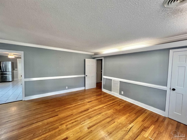 704 E Horner St, Atmore, AL 36502 - spare room with a textured ceiling, crown molding, wood finished floors, a ceiling fan, and baseboards