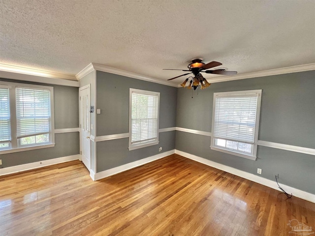 704 E Horner St, Atmore, AL 36502 - unfurnished room with wood finished floors, healthy amount of natural light, ornamental molding, ceiling fan, and baseboards
