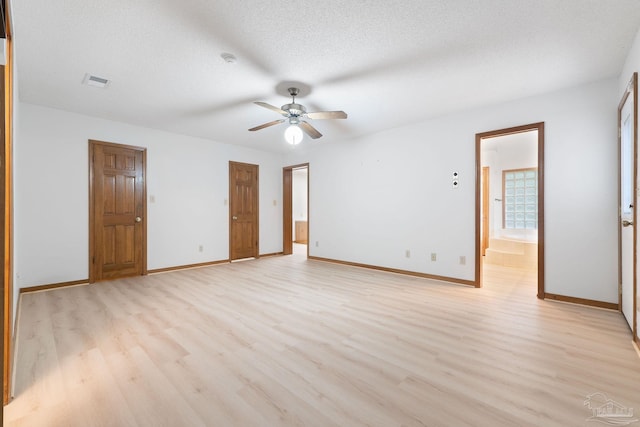 empty room with a textured ceiling, ceiling fan, and light hardwood / wood-style flooring