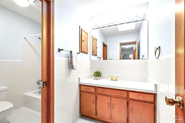 full bathroom featuring tile walls, tile patterned flooring, shower / bath combination, vanity, and toilet