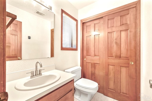 bathroom featuring vanity and toilet