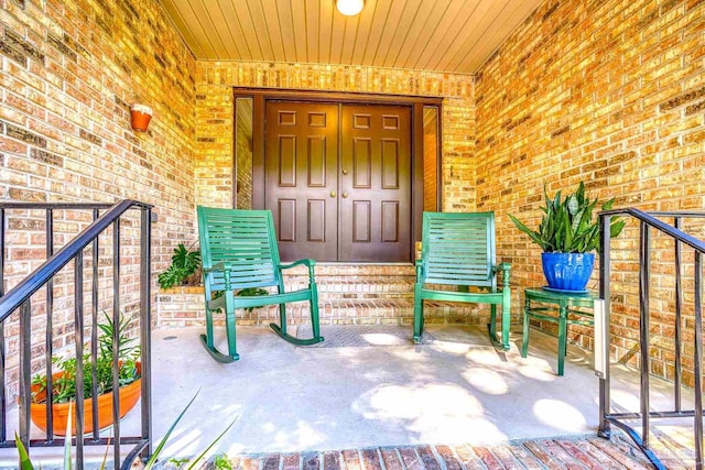 view of exterior entry with covered porch