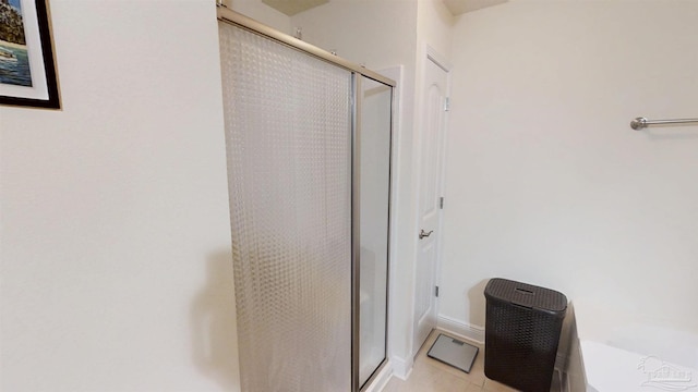 full bath featuring a stall shower and tile patterned flooring