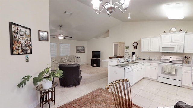 kitchen featuring a peninsula, white appliances, a sink, visible vents, and white cabinetry