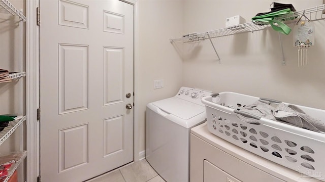 washroom featuring laundry area, separate washer and dryer, and light tile patterned flooring