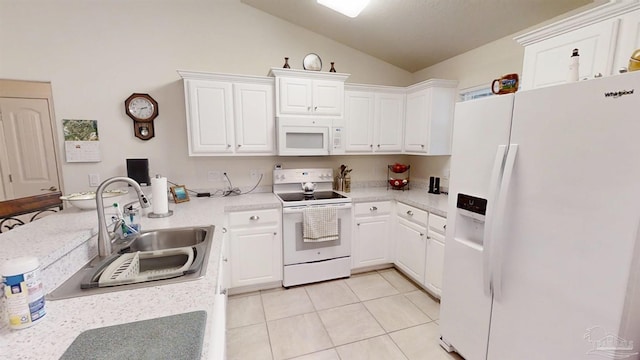 kitchen with white appliances, light tile patterned floors, a peninsula, light countertops, and a sink