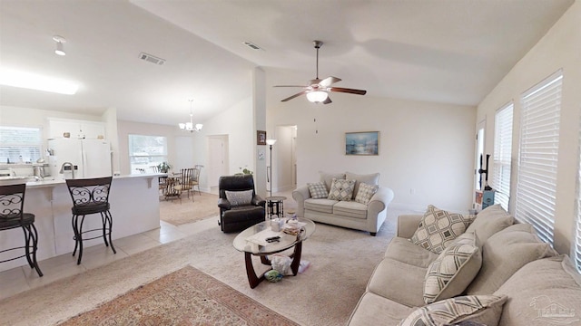 living room featuring a healthy amount of sunlight, visible vents, and light colored carpet