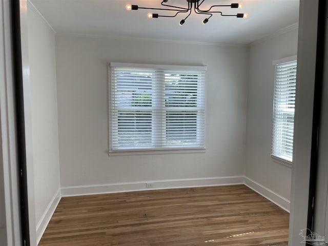 803 Pickens Ave, Pensacola, FL 32503 - spare room with a chandelier, ornamental molding, healthy amount of natural light, and wood finished floors