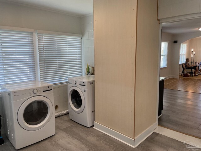 803 Pickens Ave, Pensacola, FL 32503 - washroom with washer and dryer, arched walkways, crown molding, and wood finished floors