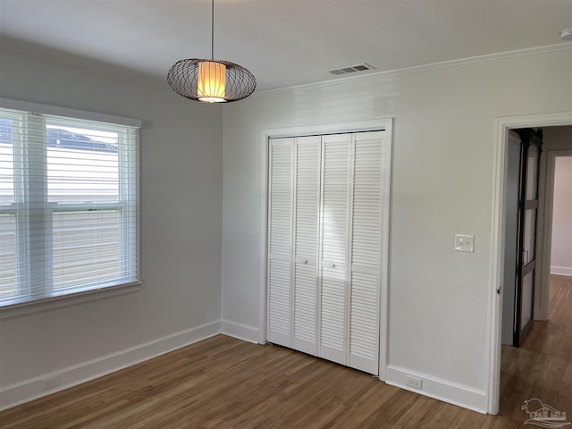 803 Pickens Ave, Pensacola, FL 32503 - unfurnished bedroom featuring wood finished floors, ornamental molding, a closet, and baseboards