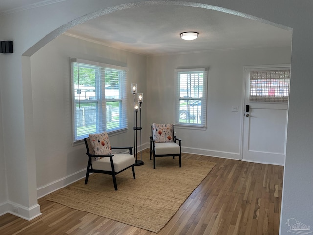 803 Pickens Ave, Pensacola, FL 32503 - living area featuring arched walkways, wood finished floors, healthy amount of natural light, and ornamental molding