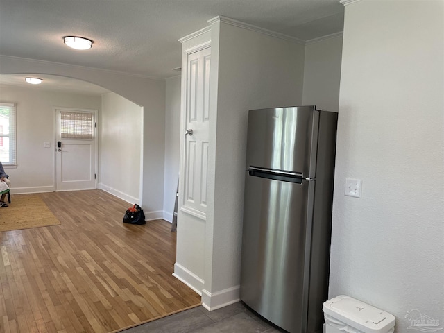 803 Pickens Ave, Pensacola, FL 32503 - kitchen featuring freestanding refrigerator, arched walkways, crown molding, wood finished floors, and baseboards