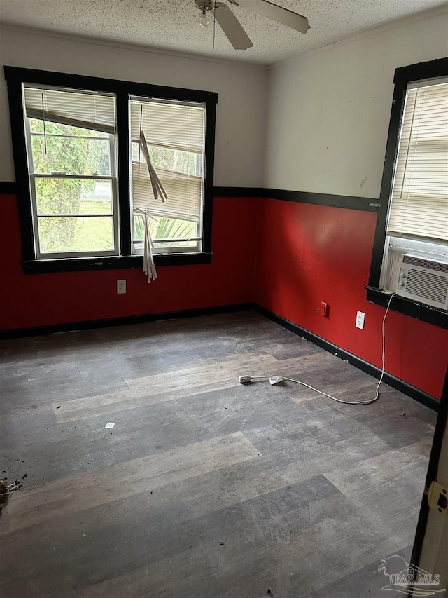 unfurnished room featuring a textured ceiling, cooling unit, and ceiling fan