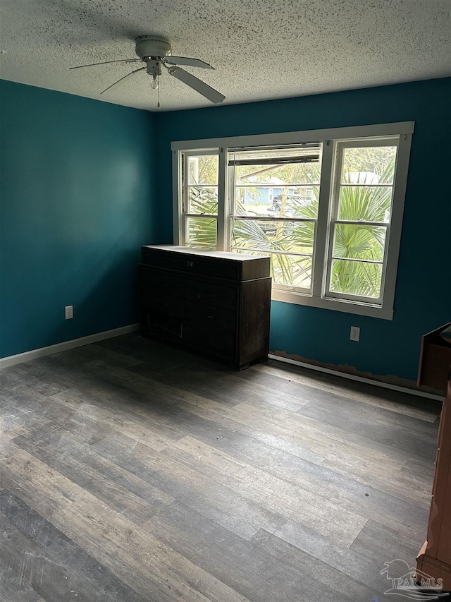 empty room featuring wood-type flooring, a textured ceiling, and ceiling fan