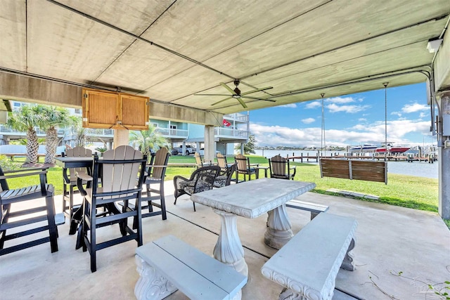 view of patio featuring a water view and a ceiling fan