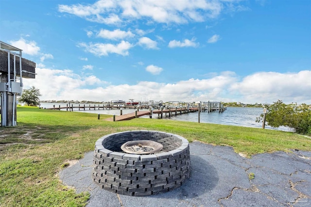 view of yard featuring an outdoor fire pit and a water view