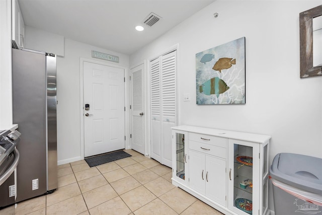 foyer entrance featuring recessed lighting, visible vents, and light tile patterned floors