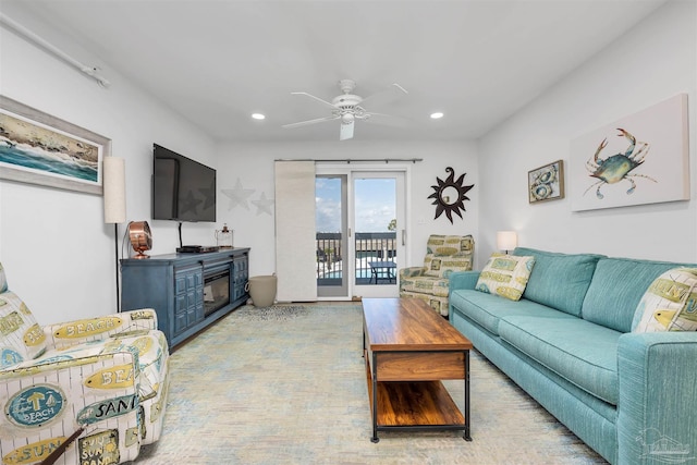 living area with a ceiling fan and recessed lighting