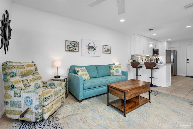 living room with a ceiling fan, recessed lighting, visible vents, and light tile patterned floors