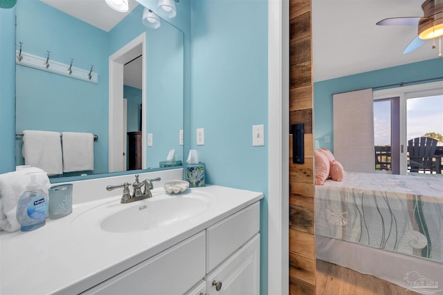 ensuite bathroom with a ceiling fan, connected bathroom, and vanity