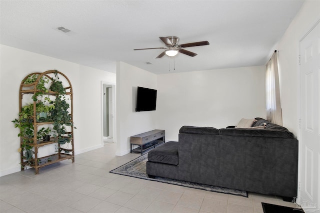 living room featuring ceiling fan and light tile patterned flooring