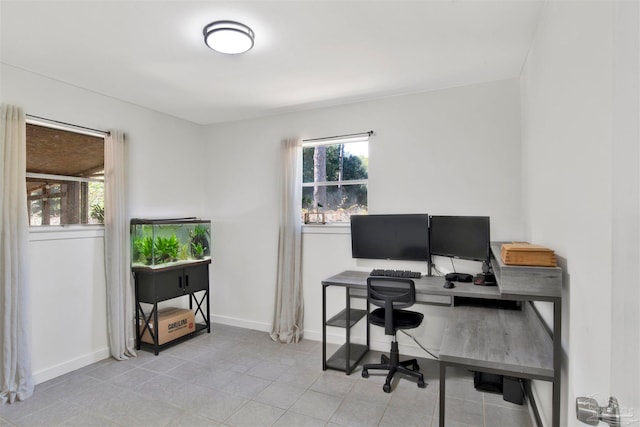 office space with a healthy amount of sunlight and light tile patterned flooring