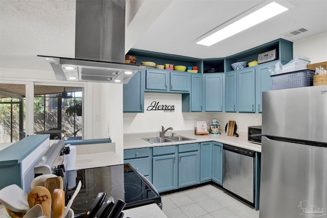 kitchen featuring island range hood, sink, appliances with stainless steel finishes, and blue cabinetry