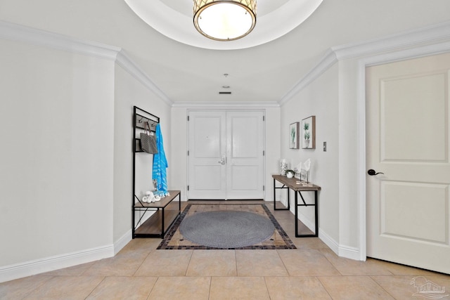 entrance foyer featuring crown molding and light tile patterned flooring