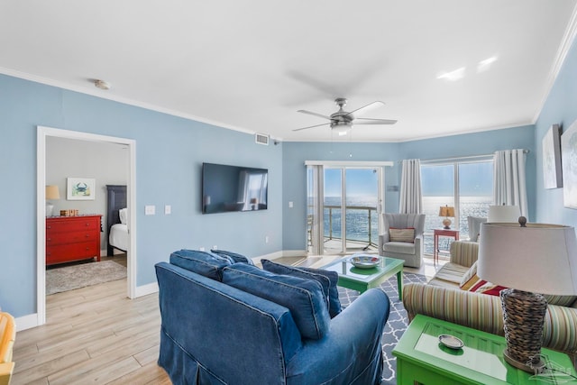 living room with light hardwood / wood-style floors, ceiling fan, and ornamental molding