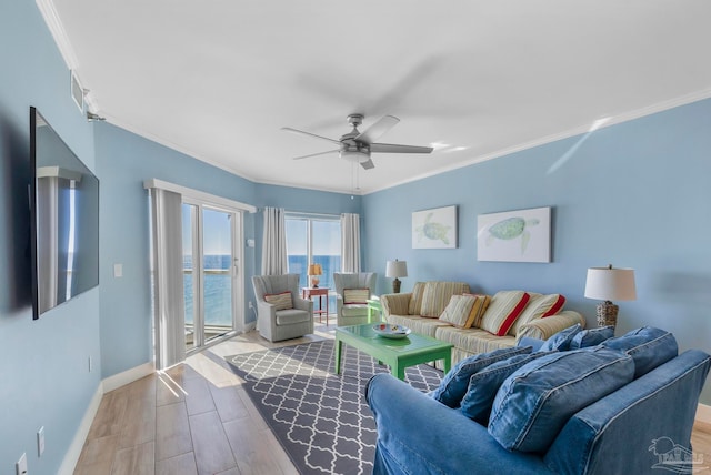 living room featuring ceiling fan, a water view, ornamental molding, and light hardwood / wood-style flooring