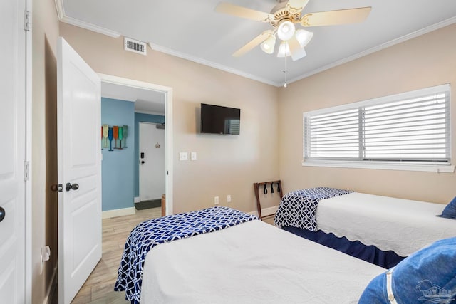 bedroom featuring ceiling fan, light wood-type flooring, and ornamental molding