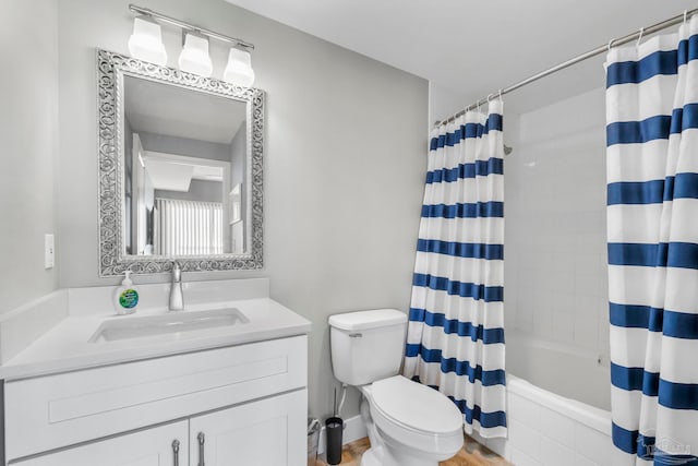 full bathroom featuring vanity, shower / tub combo, and toilet