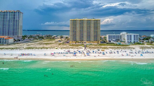 bird's eye view featuring a water view and a beach view