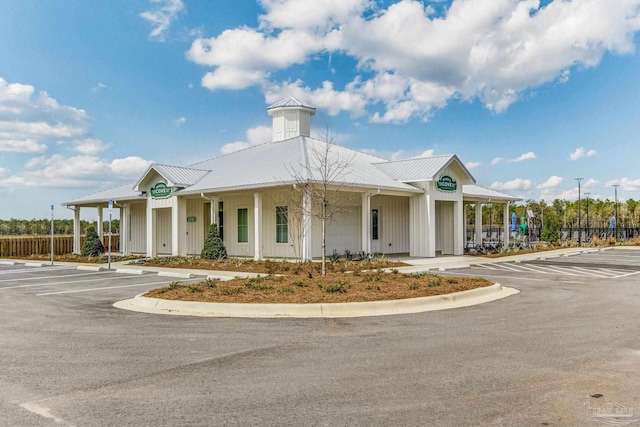 view of property featuring uncovered parking and fence