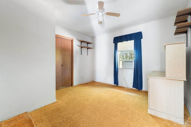 unfurnished room featuring a textured ceiling, ceiling fan, cooling unit, and light carpet