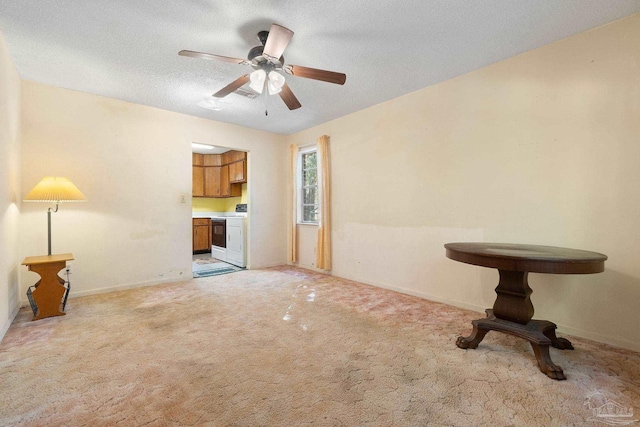 unfurnished living room featuring light carpet, a textured ceiling, and ceiling fan