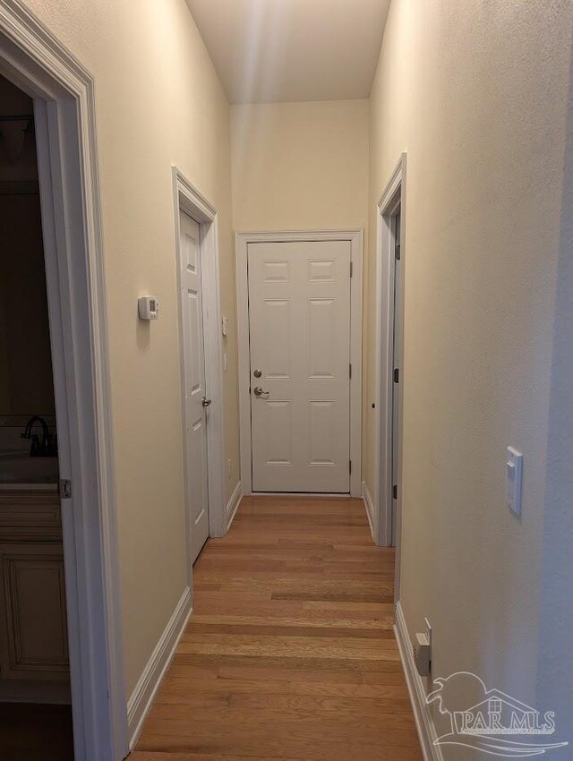 corridor with hardwood / wood-style floors